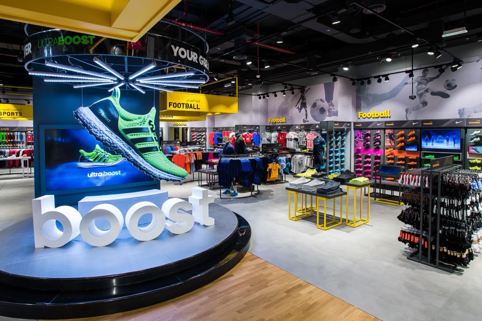 Illuminated circular product display stand with dimensional lettering in a sports store